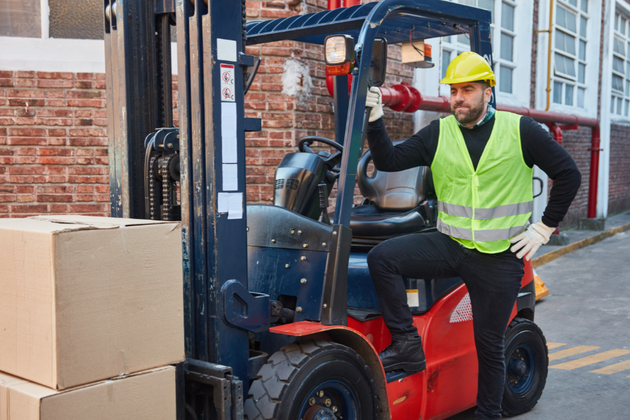 man with forklift and boxes
